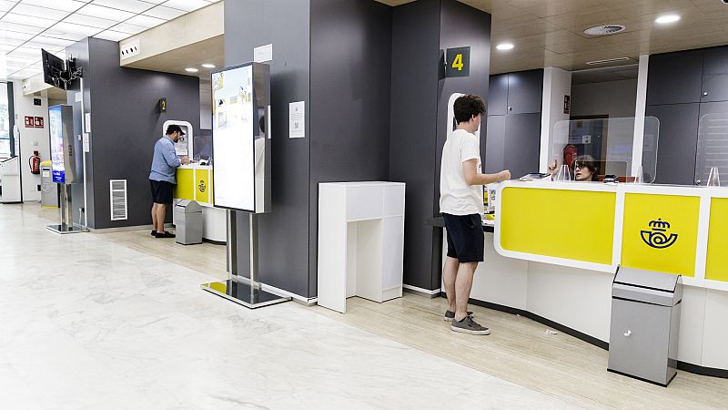 Un joven es atendido en una oficina de Correos en Madrid. Un joven es atendido en una oficina de Correos en Madrid.