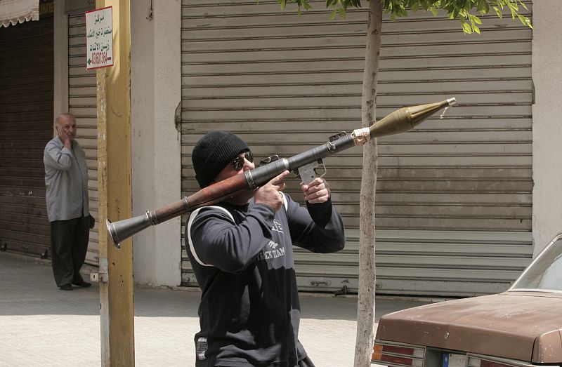 A Shi'ite opposition gunman takes position in a street in Beirut