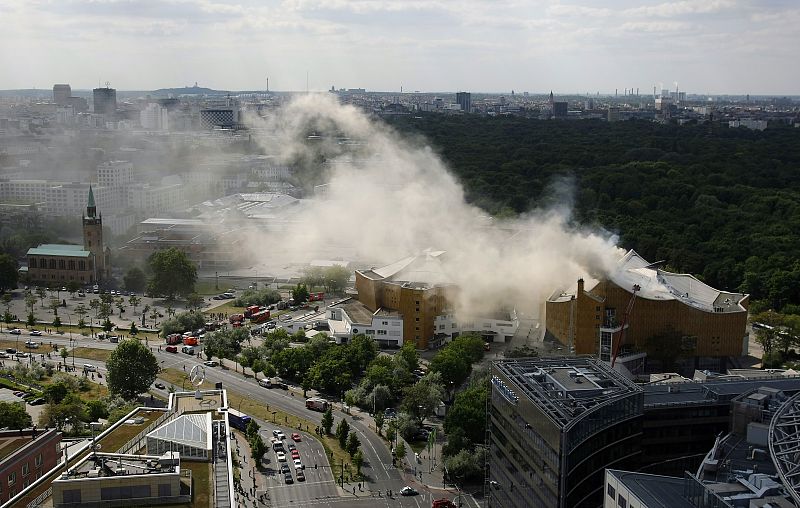 Smoke from a fire rises from the roof of the Berlin Philharmonie near Potsdamer Platz in Berlin