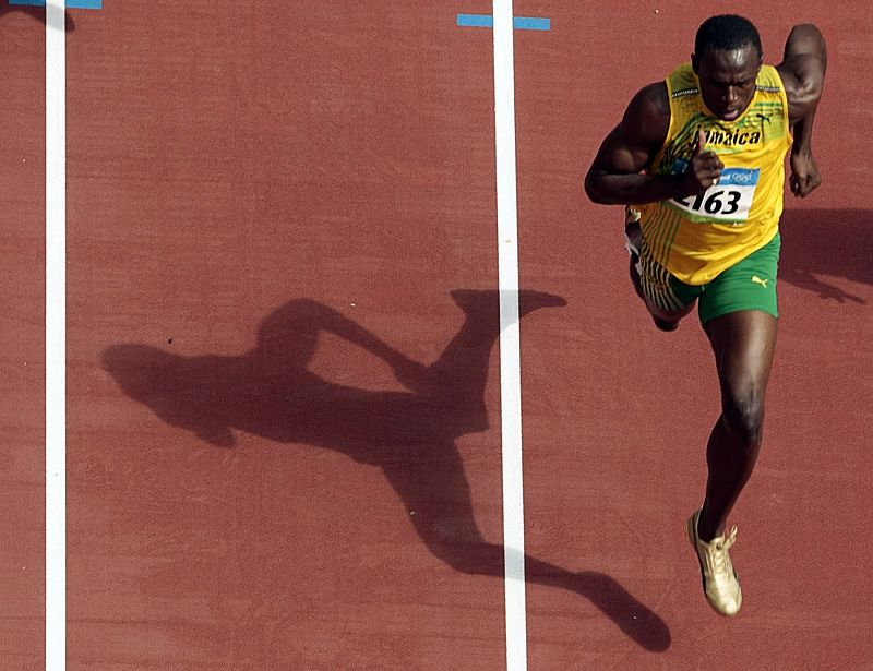 Bolt of Jamaica competes in the men's 100m heat at the National Stadium during the Beijing 2008 Olympic Games
