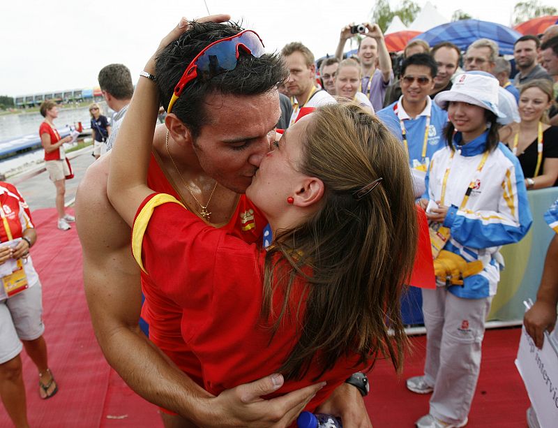 Craviotto of Spain kisses an unidentified woman after winning the men's kayak double (K2) 500m final at the Beijing 2008 Olympic Games