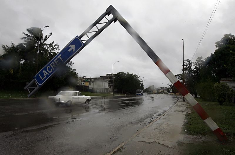 A traffic sign is seen leaning over a street after strong winds from Hurricane Ike blew across Havana