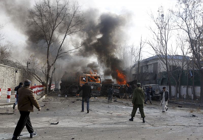 People are seen outside the German embassy following a blast in Kabul