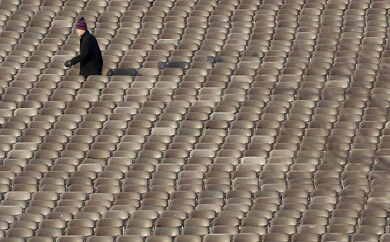 A man walks between chairs before the ticketed guests arrive for the inauguration of Obama in Washington