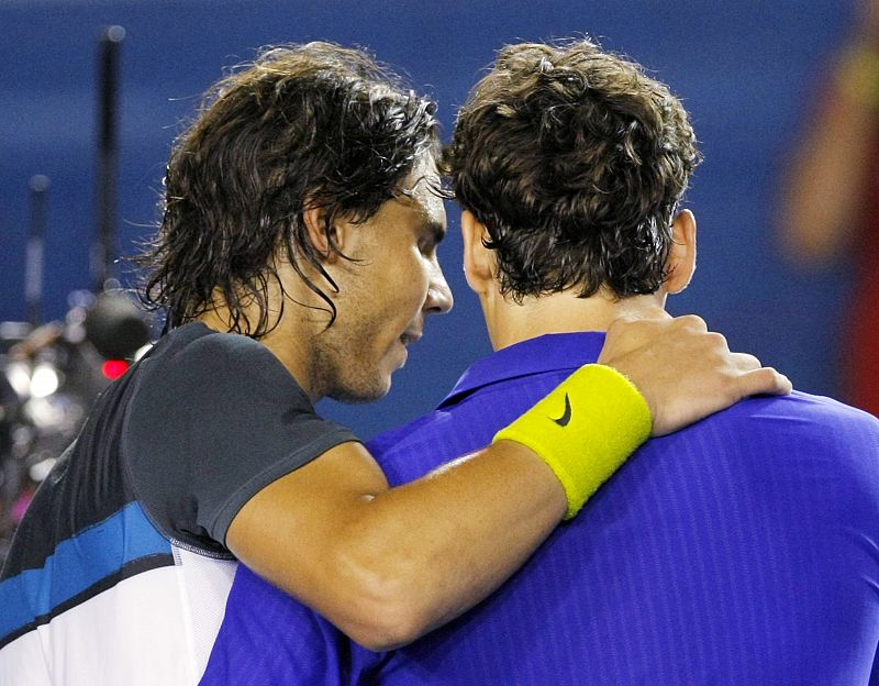 Spain's Nadal puts his arm around Switzerland's Federer after Nadal won their men's singles final match at the Australian Open