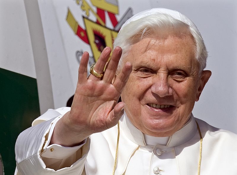 Pope Benedict XVI waves from the entrance of an airplane departing for Africa at Fiumicino international airport in Rome