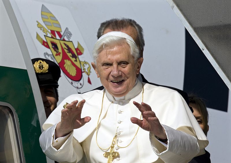 Pope Benedict XVI waves from the entrance of an airplane departing for Africa at Fiumicino international airport in Rome
