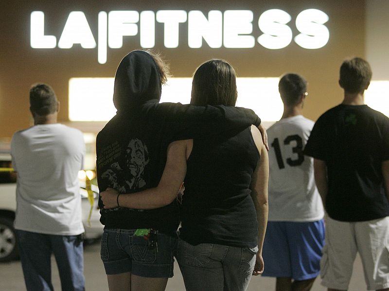 People wait behind police lines outside the LA Fitness gym in Bridgeville