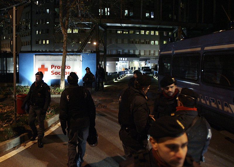 Police officers patrol outside the San Raffaele Hospital where Italy's Prime Minister Berlusconi was hospitalized in Milan