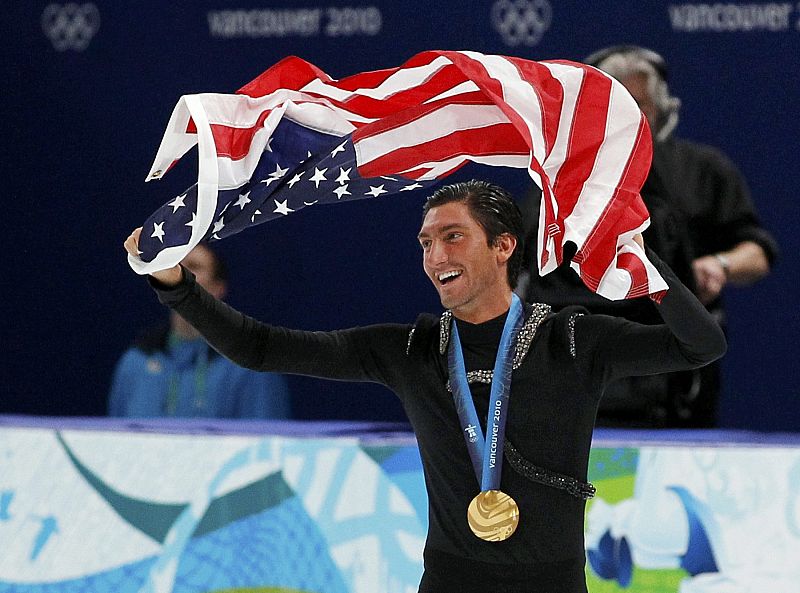 Gold medallist Lysacek of the U.S. waves his country's flag after the men's free skating figure skating competition at the Vancouver 2010 Winter Olympics