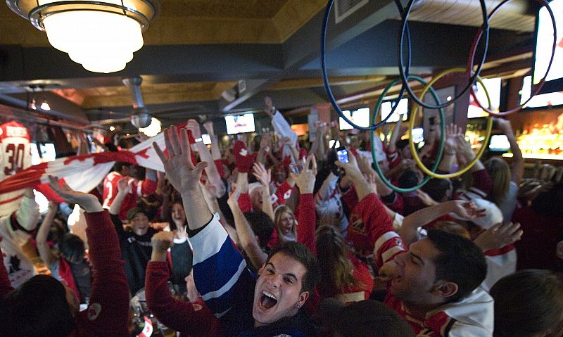 Fans celebrate Canada winning gold in men's hockey over the United States at Wayne Gretzky's Restaurant in Toronto