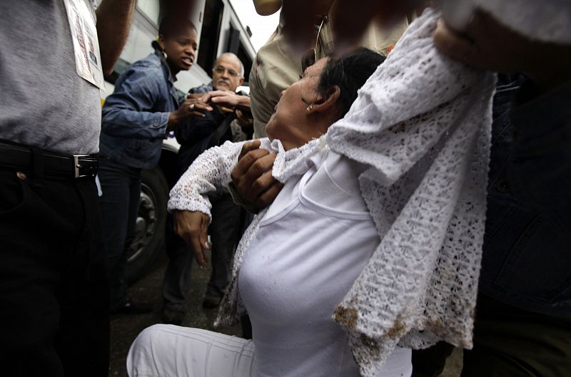 Security forces drag member of the Ladies in White into a bus after a march in Havana