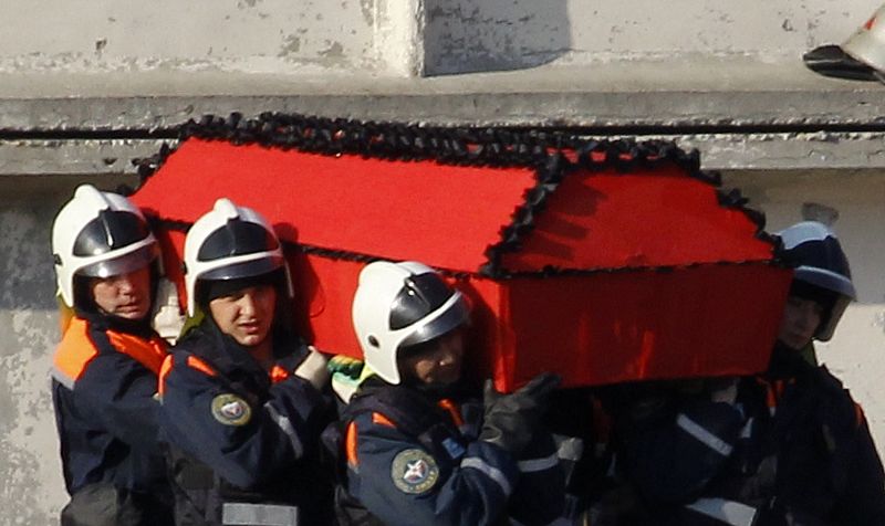 Emergencies Ministry members carry a coffin with the remains of a victim of a Polish government Tupolev Tu-154 aircraft crash to load it into a truck in Smolensk