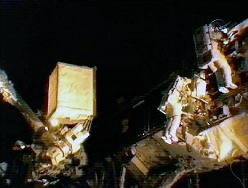 Space Shuttle Discovery astronauts Rick Mastracchio and Clayton Anderson work on installing the new ammonia tank during their spacewalk