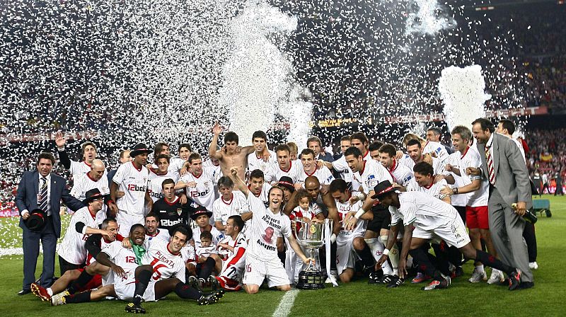 Sevilla's players pose with the trophy as they celebrate after winning their King's Cup final soccer match against Atletico Madrid at Nou Camp stadium in Barcelona
