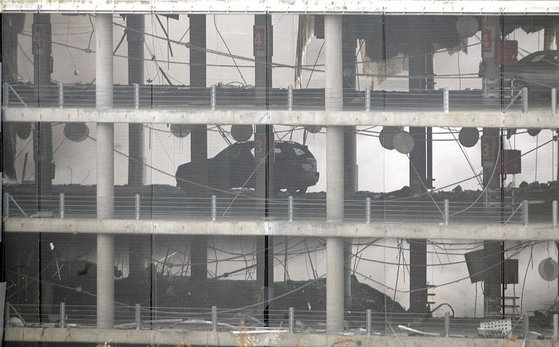 Smoke fills a parking lot of Madrid's Barajas airport after an explosion