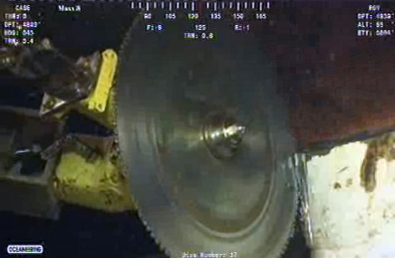 A saw mounted on a remotely operated undersea vehicle cuts through the riser pipe at the site of the Deepwater Horizon oil leak in the Gulf of Mexico