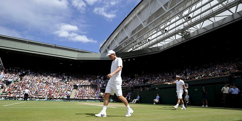 Rafael Nadal (dcha) y el checo Tomas Berdych entran en la pista central para disputar la final del torneo de tenis de Wimbledon en el club All England Lawn de Londres