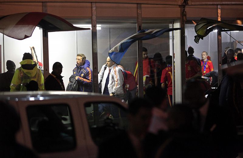 Spain's players and officials wait in line at the airport check-in as they prepare to leave in Johannesburg