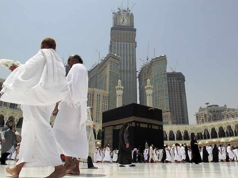 Muslim pilgrims pray inside the Grand Mosque, with the Mecca Clock in the background, on the second day of the fasting month of Ramadan in Mecca