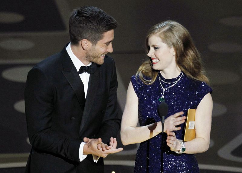 Presenters Jake Gyllenhaal and Amy Adams stand on stage during the 83rd Academy Awards in Hollywood