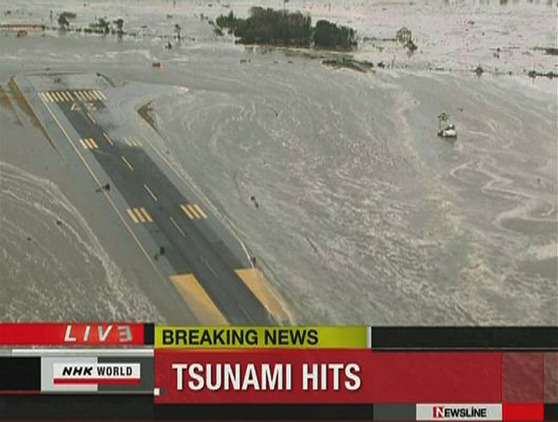 Frame grab of tsunami engulfing runway at Sendai airport