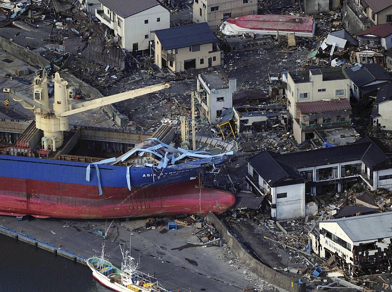 A ship is swept by waves after a tsunami and earthquake in Kamaishi City in Iwate Prefectur