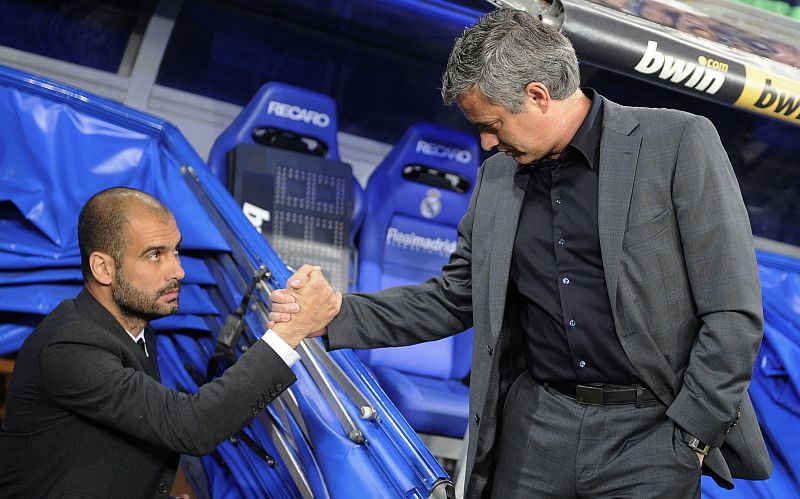 Real Madrid's coach Mourinho and Barcelona's coach Guardiola shake hands before the start of  their Spanish first division soccer match in Madrid