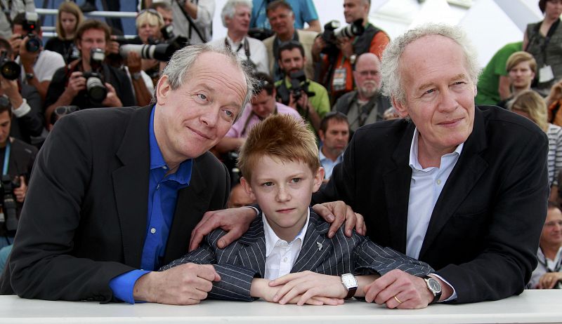 Directors Luc and Jean-Pierre Dardenne pose with cast member Doret during a photocall  for the film Le Gamin au velo" in competition at the 64th Cannes Film Festival