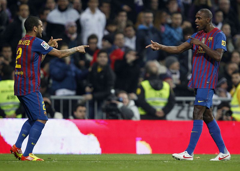 Barcelona's Eric Abidal celebrates his goal with teammate Dani Alves against Real Madrid during their Spanish King's Cup soccer match in Madrid