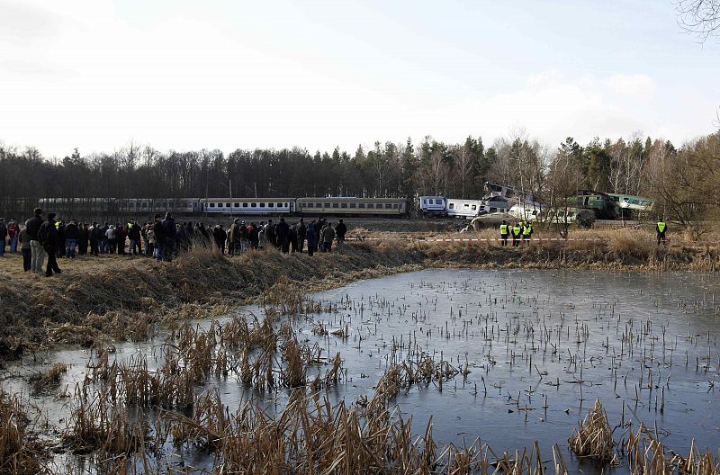 Onlookers gather at the site of a train crash near the town of Szczekociny