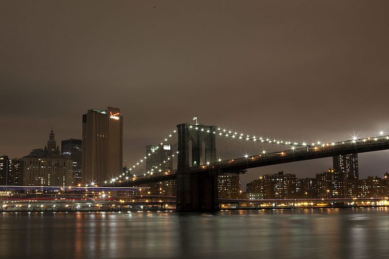 The Brooklyn Bridge is seen before the lights are turned off, in participation with Earth Hour, in New York