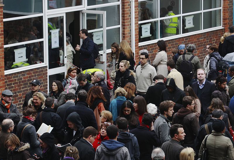 French nationals queue to cast their votes in France's Presidential election at the Lycee Francais Charles de Gaulle in London