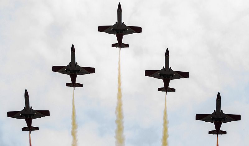 Spanish Air Force aerobatic group Patrulla Aguila display colours during the military parade to mark Armed Forces Day in Valladolid