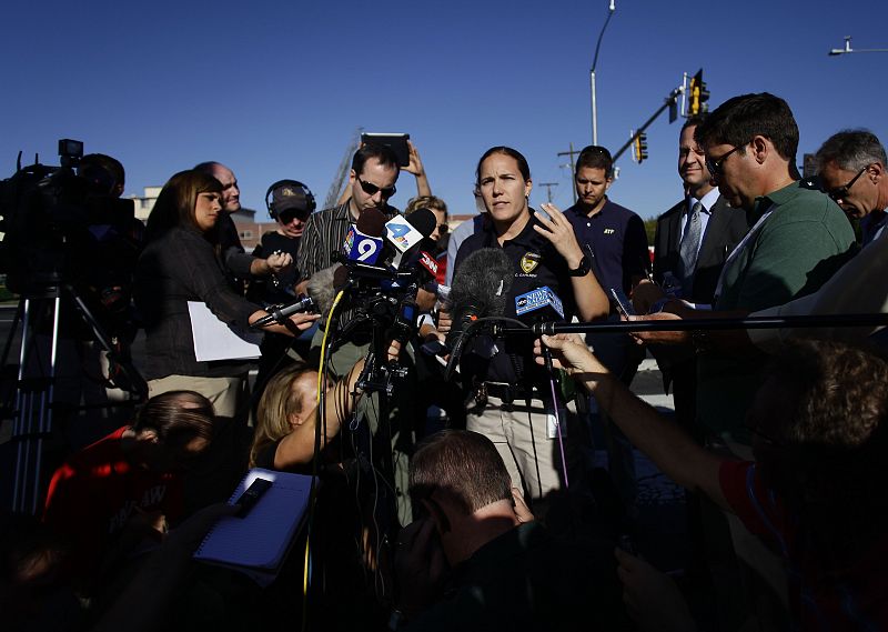 Aurora police spokeswoman Carlson briefs reporters during a news conference near the apartment complex where suspect Holmes lived in Aurora