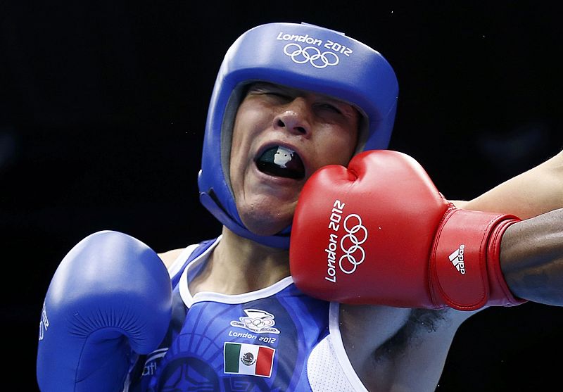 Canada's Clayton lands a punch as he fights against Mexico's Molina Casillas in the men's welter (69kg) Round of 32 boxing match during the London 2012 Olympic Games