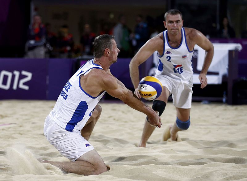 Czech Republic's Premysl Kubala digs the ball for Petr Benes against Todd Rogers and Phil Dalhausser of the U.S. during their men's preliminary round beach volleyball match at Horse Guards Parade during the London 2012 Olympic Games