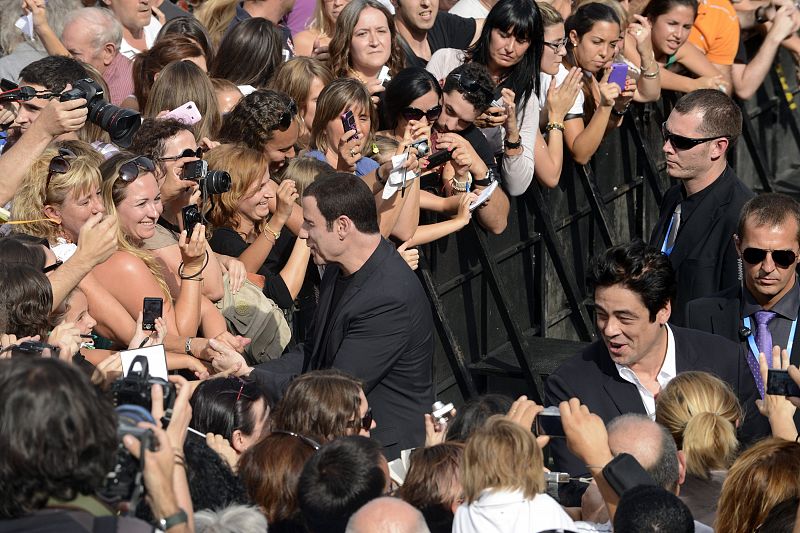 Travolta and del Toro greet fans following a photocall to promote the film Savages on the third day of the San Sebastian Film Festival