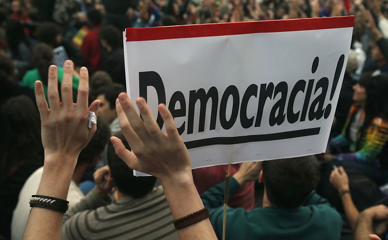 Protesters take part in a demonstration outside Madrid's Parliament