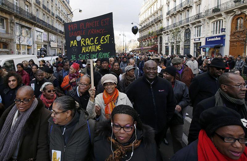 A woman holds a banner as she attends a protest march called "The March for Equality and against Racism" in Paris