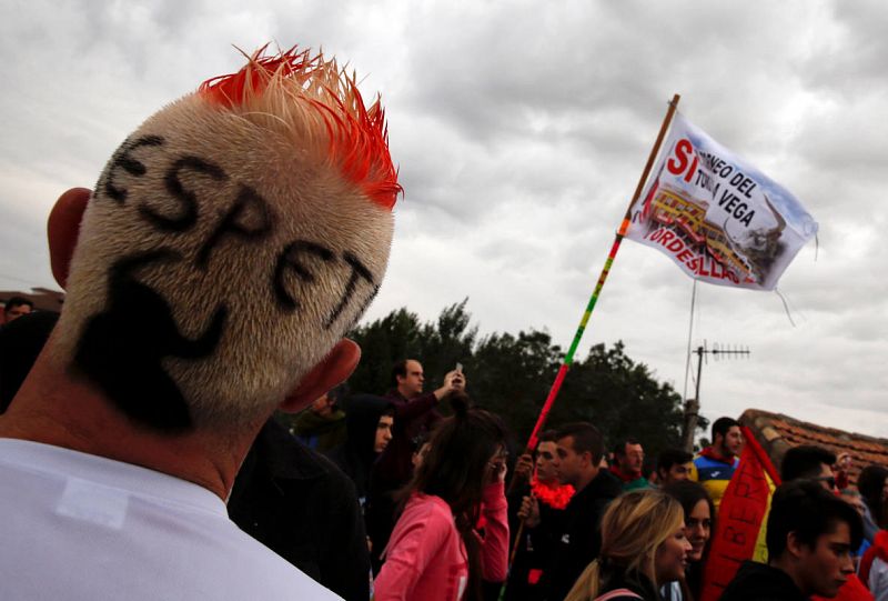 A man with a shape of a bull and the word "respect" painted in his hair stands before the start of the Toro de la Pena, formerly known as Toro de la Vega festival, in Tordesillas