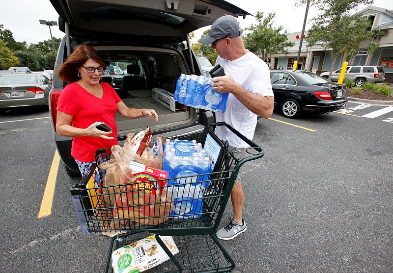 Laura and George Callahan of James Island, South Carolina, load up their vehicle with bottled water and food purchased ahead of the arrival of Hurricane Matthew, in Folly Beach