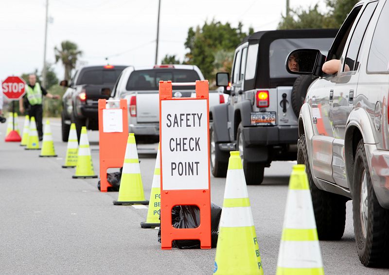Residents and workers are stopped at a safety check point ahead of the arrival of Hurricane Matthew, in Folly Beach