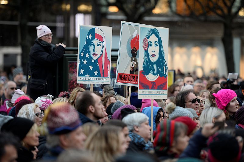 Protesters carrying banners and placards take part in a Women's March in Stockholm, Sweden