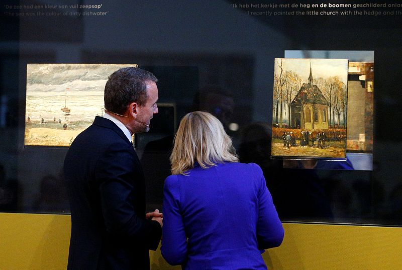Museum director Axel Ruger and Dutch Minister of Education, Culture and Science Jet Bussemaker reveal two recovered paintings by Vincent van Gogh, which were stolen from the museum in 2002, at the van Gogh Museum in Amsterdam