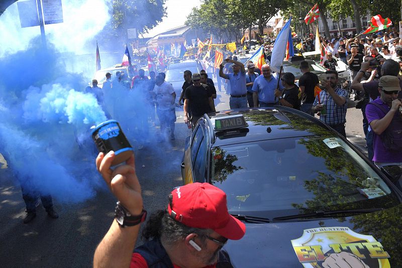 Un manifestante porta un bote de humo, en las proximidades de la estación de Atocha.