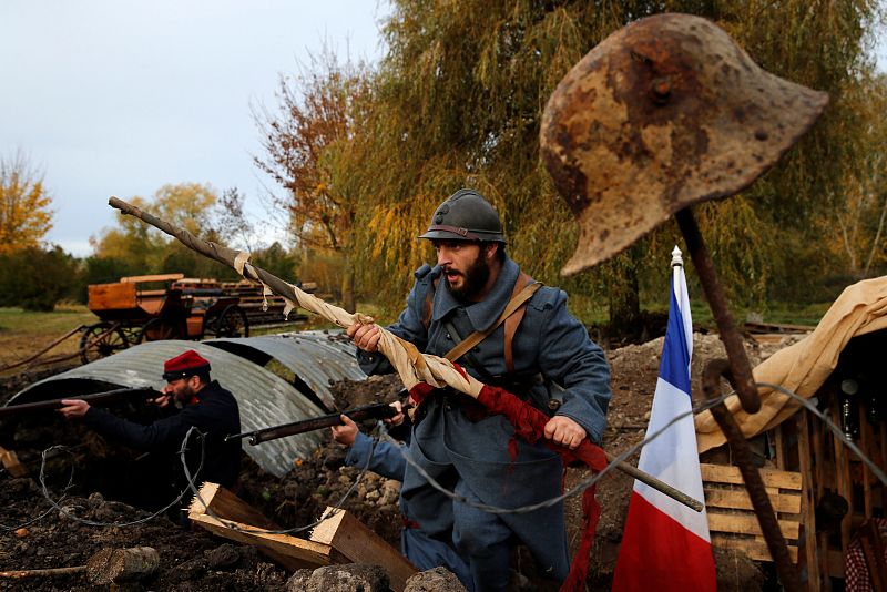 History enthusiasts, members of French association Tempus Fugit, dressed in World War One French military outfits, re-enact daily life of soldiers during trench warfare, in Ecourt-Saint-Quentin