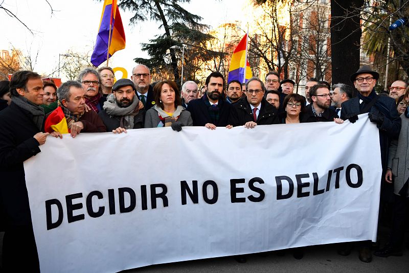 Torra y Torrent con una pancarta donde se lee "Decidir no es delito"