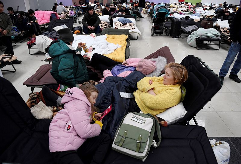 People rest at a refugee reception center at the Ukrainian-Polish border crossing in Korczowa