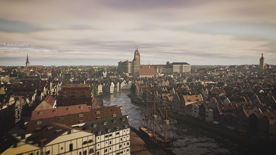 Fotografía de ciudad con río, barcos, iglesia y castillo